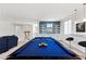 Open game room featuring a billiards table with striking blue felt alongside a comfortable seating area at 6338 Skystone St, Las Vegas, NV 89135
