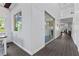 Hallway with wood floors, and a partial view into the office and other living spaces at 6338 Skystone St, Las Vegas, NV 89135