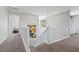 Bright hallway with elegant stair railing and modern light fixtures at 6338 Skystone St, Las Vegas, NV 89135