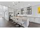 Bright, open kitchen featuring a large island, stainless steel appliances, and stylish white cabinets at 6338 Skystone St, Las Vegas, NV 89135