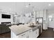 Open kitchen with granite island, stainless steel appliances, and views of the living area at 6338 Skystone St, Las Vegas, NV 89135