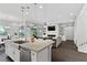 Open kitchen with granite island, stainless steel appliances, and views of the living area at 6338 Skystone St, Las Vegas, NV 89135
