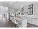 Bright, open kitchen featuring a large island, stainless steel appliances, and stylish white cabinets at 6338 Skystone St, Las Vegas, NV 89135