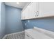 Well-lit laundry room featuring ample storage and stylish countertops at 6338 Skystone St, Las Vegas, NV 89135