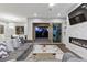 Cozy living room featuring a modern fireplace, comfortable seating, and sliding doors to the backyard at 6338 Skystone St, Las Vegas, NV 89135