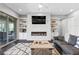 Cozy living room with a modern fireplace, built-in shelving, and a comfortable seating area at 6338 Skystone St, Las Vegas, NV 89135