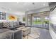 Bright living room with fireplace, sectional sofa and sliding glass doors leading to outdoor patio and garden at 6338 Skystone St, Las Vegas, NV 89135