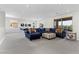 Spacious living room with a plush sofa, carpet flooring, and views of the outdoor landscape at 6338 Skystone St, Las Vegas, NV 89135