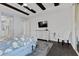 Spacious main bedroom with decorative wood beam ceiling, dresser, ensuite bathroom and backyard access at 6338 Skystone St, Las Vegas, NV 89135