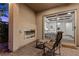 Outdoor patio features a modern fireplace, seating, and sliding glass doors leading to the primary bedroom at 6338 Skystone St, Las Vegas, NV 89135