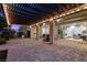 Backyard covered patio with recessed lighting, outdoor fans, a fireplace, and easy access to the home's interior at 6338 Skystone St, Las Vegas, NV 89135