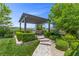 Picturesque pergola with seating and lush landscaping, creating a private outdoor oasis with a serene and inviting atmosphere at 6338 Skystone St, Las Vegas, NV 89135