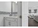 Chic powder room with wainscoting and a mosaic tile accent wall, located adjacent to the home's kitchen at 6338 Skystone St, Las Vegas, NV 89135