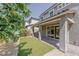 Grassy backyard with a covered patio and sliding glass doors at 6403 Ava Ridge Ave, Las Vegas, NV 89141