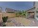 Landscaped backyard with gravel, brick pavers, artificial turf, and covered patio at 6403 Ava Ridge Ave, Las Vegas, NV 89141
