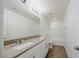 Bathroom featuring double sink vanity and shower over tub with white tile surround at 6403 Ava Ridge Ave, Las Vegas, NV 89141