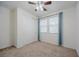 Bedroom featuring neutral carpet, white walls, and a ceiling fan at 6403 Ava Ridge Ave, Las Vegas, NV 89141