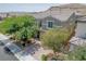 A charming two-story home with a paved driveway, lush landscaping, and mountain views at 6403 Ava Ridge Ave, Las Vegas, NV 89141