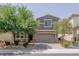 Charming home featuring a well-manicured lawn and a two-car garage at 6403 Ava Ridge Ave, Las Vegas, NV 89141