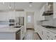 Modern kitchen with white cabinets, stainless steel appliances, and granite countertops at 6403 Ava Ridge Ave, Las Vegas, NV 89141