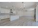 Bright living room with hardwood floors, modern lighting, and a neutral color palette at 6403 Ava Ridge Ave, Las Vegas, NV 89141