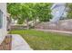 Backyard featuring a patch of grass, a tree with a swing, a walkway, and a block wall at 7267 W Mesa Vista Ave, Las Vegas, NV 89113