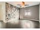 Bedroom featuring stylish accent wall, dark floors and ceiling fan at 7267 W Mesa Vista Ave, Las Vegas, NV 89113