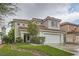 Charming two-story home with a well-manicured lawn and a two-car garage with a new roof and green grass at 7267 W Mesa Vista Ave, Las Vegas, NV 89113