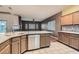 Modern kitchen with granite countertops, stainless steel appliances, and tile backsplash at 7267 W Mesa Vista Ave, Las Vegas, NV 89113