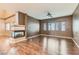 Bright living room featuring a modern fireplace and wood flooring at 7267 W Mesa Vista Ave, Las Vegas, NV 89113