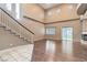 Open-concept living space features a staircase, sliding door, and modern fireplace at 7267 W Mesa Vista Ave, Las Vegas, NV 89113