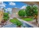 Private backyard features lush landscaping, a stone pathway, and a quaint outdoor building at 768 Lawrence Dr, Henderson, NV 89015