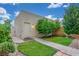 Secluded backyard with mature trees, green lawn, and an external storage building, creating a serene setting at 768 Lawrence Dr, Henderson, NV 89015