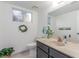 Bathroom with a solid surface vanity top, ample mirror, and decorative plant accents at 768 Lawrence Dr, Henderson, NV 89015