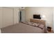 Neutral bedroom with wood-look floors, double closets, and a dresser with television at 768 Lawrence Dr, Henderson, NV 89015