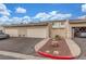 Exterior shot of townhomes showing garages, parking, desert landscaping, and neat curb appeal at 768 Lawrence Dr, Henderson, NV 89015