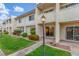 Charming two-story condo with well-manicured lawn, mature landscaping, and a welcoming entryway at 768 Lawrence Dr, Henderson, NV 89015