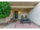 Charming front porch includes an outdoor dining set and welcoming entry door with decorative wreath at 768 Lawrence Dr, Henderson, NV 89015