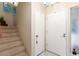 Hallway with staircase and two white doors at 768 Lawrence Dr, Henderson, NV 89015