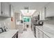 Well-lit kitchen featuring stainless steel appliances, marble countertops, and tiled floors at 768 Lawrence Dr, Henderson, NV 89015
