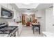 Open kitchen overlooking dining area, featuring stainless steel appliances and marble countertops at 768 Lawrence Dr, Henderson, NV 89015