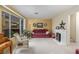 Cozy living room features a fireplace, large windows, and comfortable seating at 768 Lawrence Dr, Henderson, NV 89015