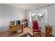 Office space featuring a large window, desk, and a comfortable rocking chair at 768 Lawrence Dr, Henderson, NV 89015