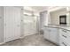 Bathroom with white cabinets, granite countertops, a glass-enclosed shower, and tile flooring at 7733 Rosebark Cliffs St, North Las Vegas, NV 89084