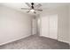 Bedroom featuring modern ceiling fan, a closet, doorways, and carpeted flooring at 7733 Rosebark Cliffs St, North Las Vegas, NV 89084