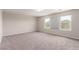 Large bedroom with three windows offering plenty of light, and neutral carpet at 7733 Rosebark Cliffs St, North Las Vegas, NV 89084