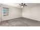 Bedroom featuring neutral walls, carpet, a modern ceiling fan, and a bright window at 7733 Rosebark Cliffs St, North Las Vegas, NV 89084