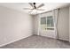 Bedroom featuring modern ceiling fan, a window with white curtains, and carpeted flooring at 7733 Rosebark Cliffs St, North Las Vegas, NV 89084