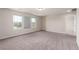 Spacious bedroom with windows letting in natural light, neutral paint, and plush carpet at 7733 Rosebark Cliffs St, North Las Vegas, NV 89084