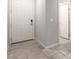 Clean entryway with a white front door and tile flooring, leading into the home's interior at 7733 Rosebark Cliffs St, North Las Vegas, NV 89084